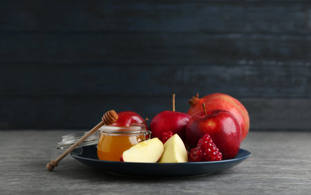 Honey apples and pomegranate on gray table rosh hashanah holiday Stock Photo