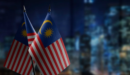 Small flags of the malaysia on an abstract blurry background