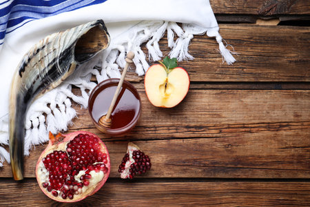 Honey pomegranate apples and shofar on wooden table flat lay with space for text rosh hashanah holiday