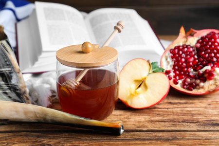 Honey pomegranate apples and shofar on wooden table rosh hashanah holiday