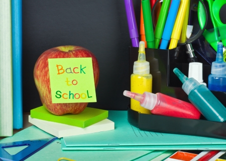 Paper sticker with text back to school pasted on the apple Stock Photo