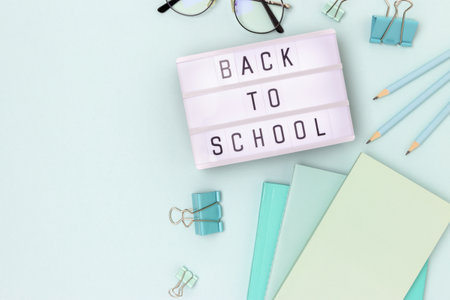 Back to school lightbox with letters and stationery on a blue background concept with copy space Stock Photo