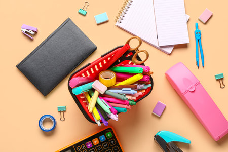 Shopping basket with different school stationery on beige background Stock Photo