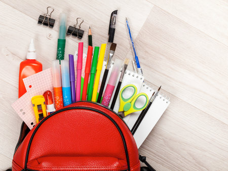 Stationery for studying against the background of a student s backpack close up