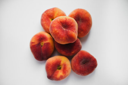 Flat peaches on a white background peaches in a package Stock Photo