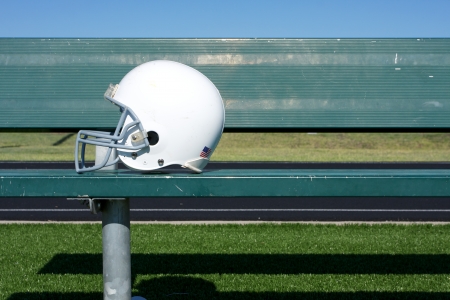 American football helmet on the bench with room for copy Stock Photo