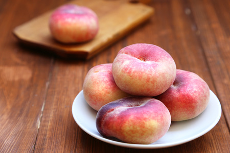 Some fresh ripe peaches on wooden background