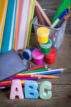 School supplies labeled abc on a wooden background Stock Photo