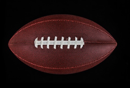 Flying rugby ball isolated on black