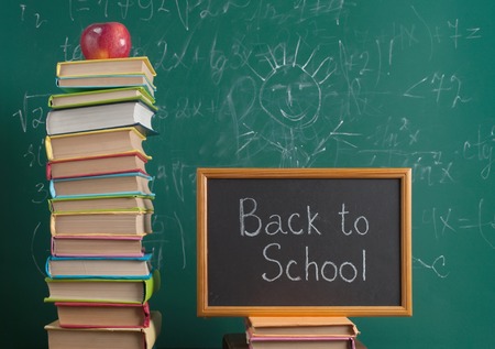 Books on the background of the school board Stock Photo