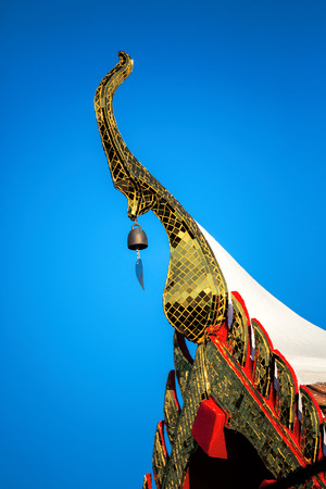 Ornemental roof points shaped like the head of the garuda on the temple in thailand Stock Photo