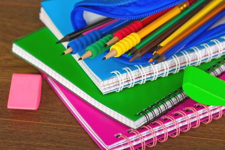 Back to school blackboard with pencilbox and school equipment on table