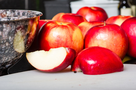 Red apples on cutting board sliced ready to cook