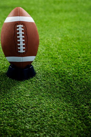 American football standing on holder on american football field Stock Photo