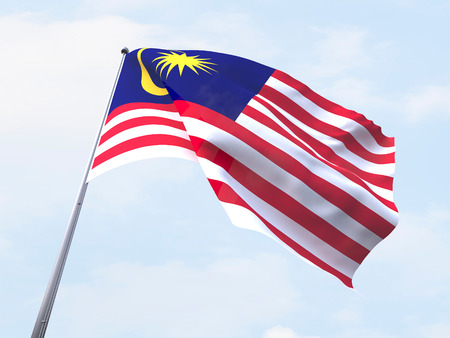 Malaysia flag flying on clear sky Stock Photo