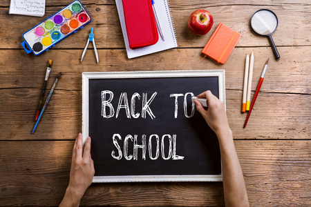 Desk with school supplies studio shot on wooden background Stock Photo