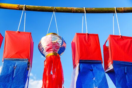 Paper lanterns on blue sky in yee peng festival loy krathong celebration in chiangmai thailand