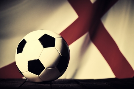 Flag of england with football on wooden boards as the background vintage style