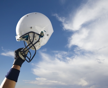 Football helmet raised in victory