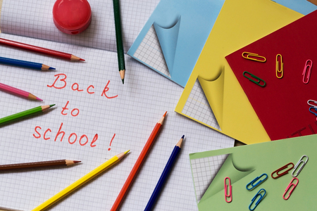 Back to school school supplies on the background of notebook sheet in a cage Stock Photo