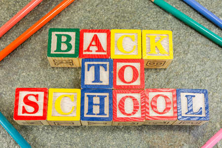 Back to school written with wooden letters and pencils