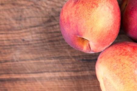 Fresh juicy peaches on a wooden cutting board Stock Photo