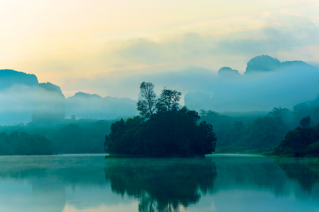 Small island on a slightly foggy at early morning Stock Photo