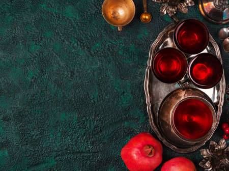 Pomegranates and pomegranate juice on textural background top view with copy space