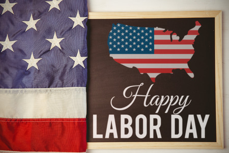 Poster of happy labor day text against american flag on chalkboard