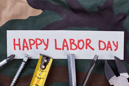 Happy labor day greeting card instruments on camouflage cloth creative way of congratulation