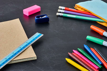 School supplies on blackboard back to school background