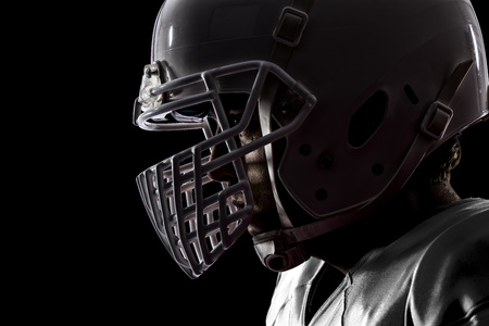 Close up of a football player with a white uniform on a black background