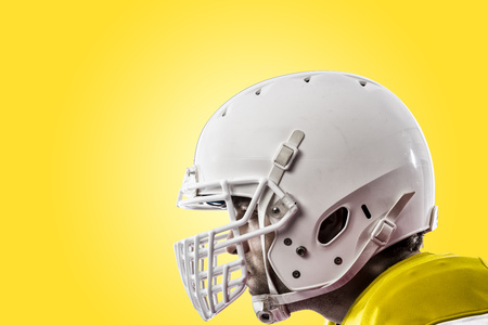 Close up of a football player with a yellow uniform on a yellow background