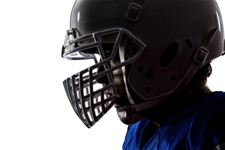 Close up of a football player with a blue uniform on a white background Stock Photo