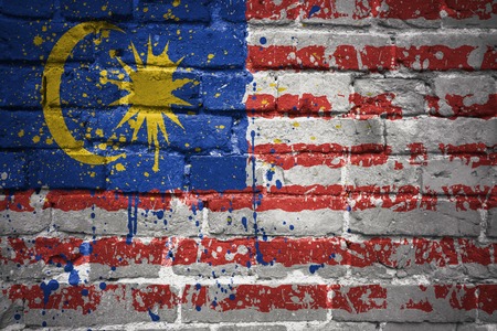 Colorful painted national flag of malaysia on a old brick wall