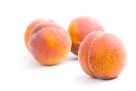 Four peaches on white background