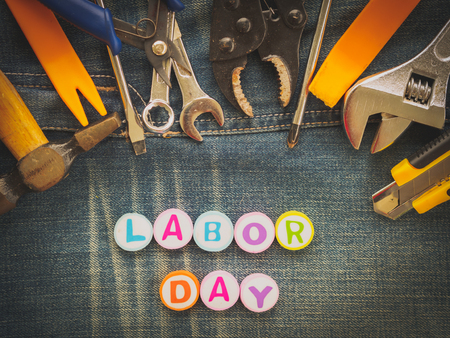 Labor day background concept jeans many handy tools with labor day text on jeans background top view Stock Photo