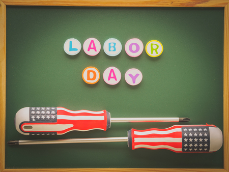 Labor day background concept many handy tools with labor day text on blackboard background top view