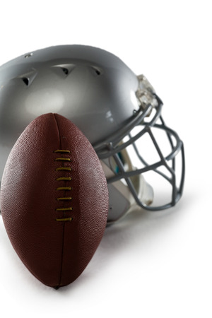 Close up of football and sports helmet against white background