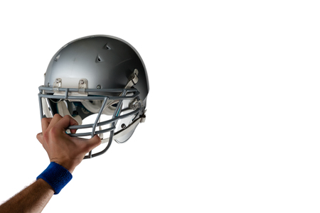 Cropped image of hand holding helmet against white background