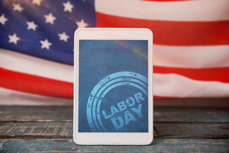 Blurry animated flare against digital tablet on table against american flag