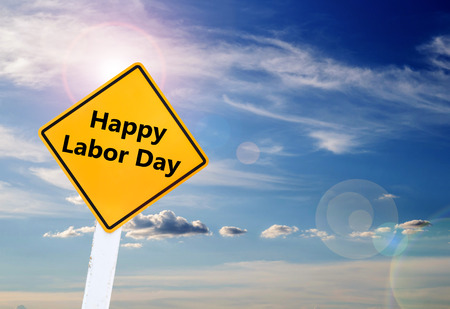 Labor day is a federal holiday of united states america text for happy labor day on yellow road sign with blurred blue sky and cloud background with sunlight space for any design