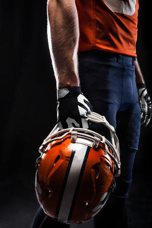 American football sportsman player on black background