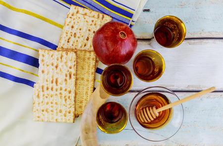 Beautiful green yellow and red apples pomegranates and lemons with honey on a wooden background the traditional jewish holiday rosh hashanah jewish new year concept Stock Photo