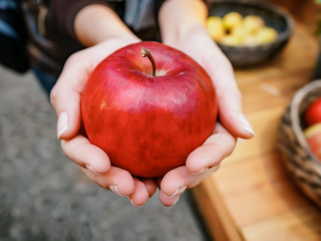 Woman hand with big red apple