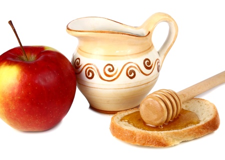 Honey in a jug and apple isolated on white background