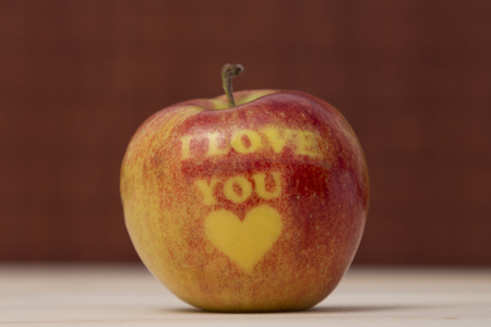 Red apple close up on the wooden table