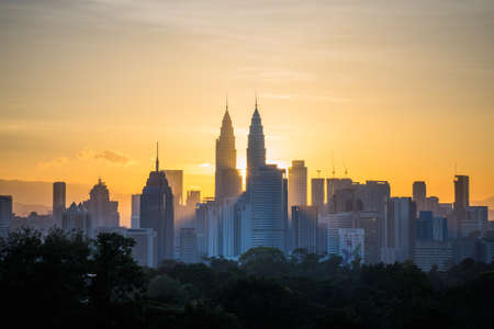 Beautiful aerial view kuala lumpur city in the morning with dramatic sky clouds and sun rays